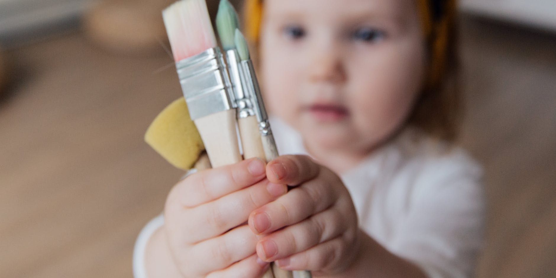 pexels-photo-3933280 Child holding paint brushes - Inspire & Play Early Learning - Endeavour Hills